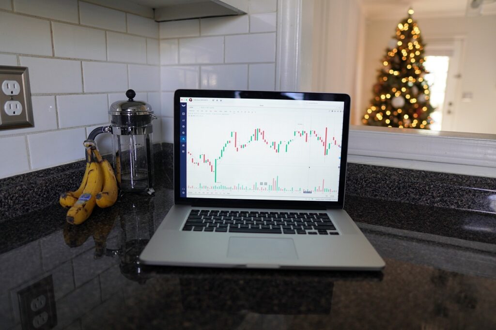A laptop with financial charts on kitchen side