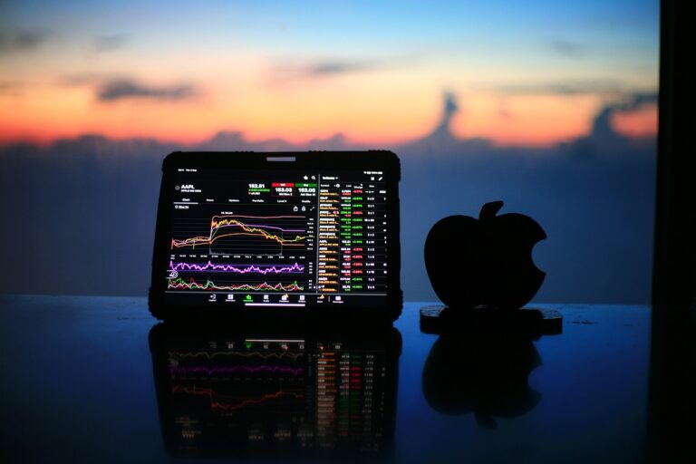 image of chart on laptop with an apple beside it