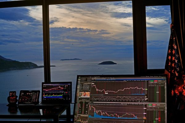image of trading chart on a laptop with ocean view
